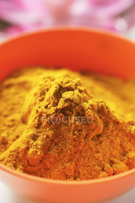 Turmeric in orange bowl — Stock Photo