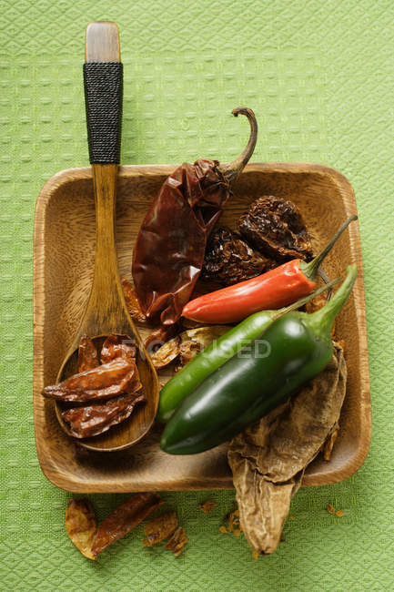 Various dried and fresh chili peppers — Stock Photo