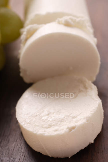 Goat's cheese on wooden surface — Stock Photo