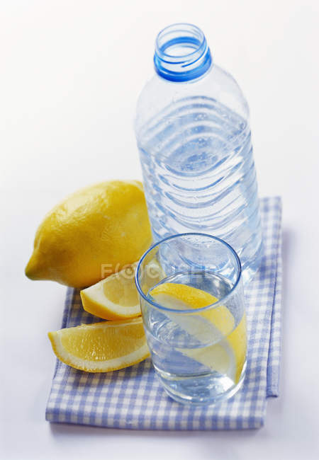 Bottle and glass of mineral water — Stock Photo
