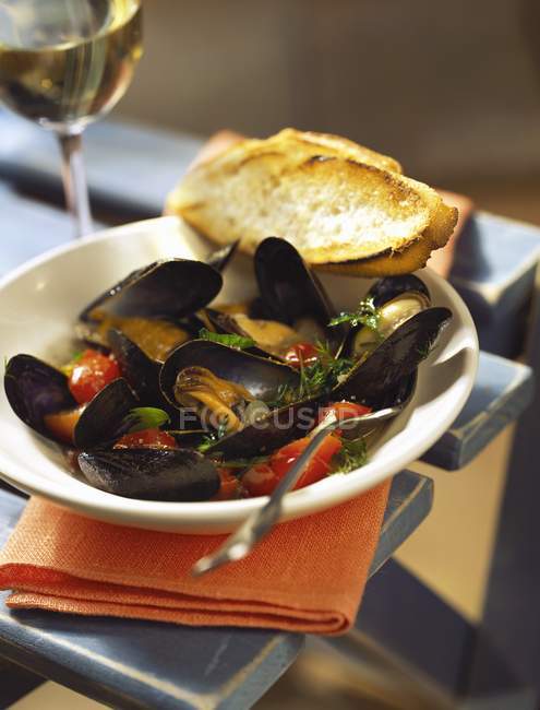 Mussels in wine sauce with herbs — Stock Photo