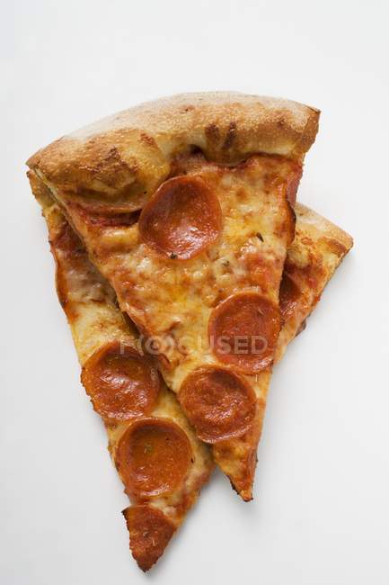 Pieces of pepperoni pizza — Stock Photo