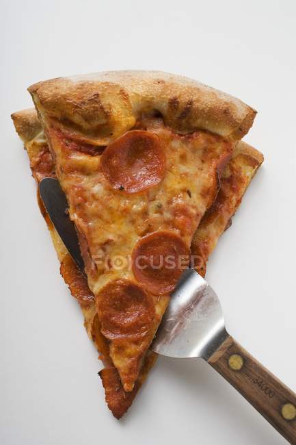 Pieces of pepperoni pizza — Stock Photo