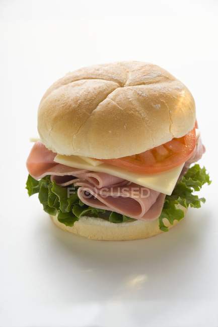 Cheese and tomato in kaiser roll — Stock Photo