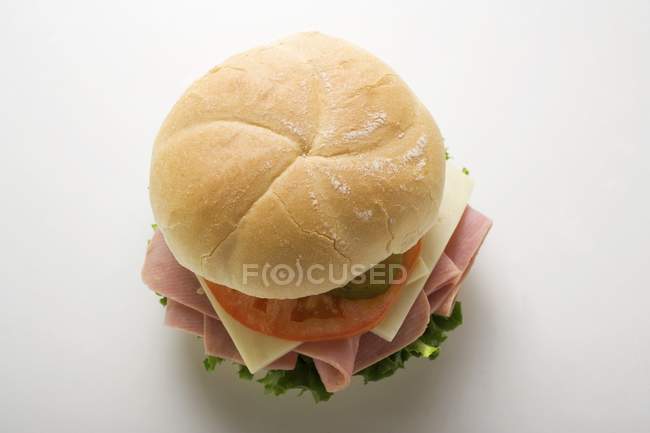 Ham and gherkin in kaiser roll — Stock Photo