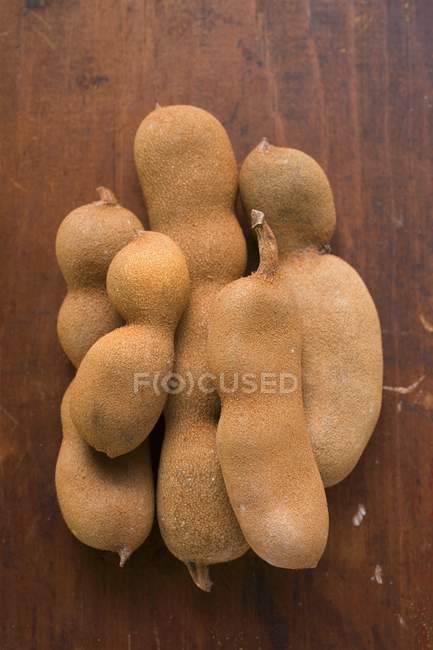 Tamarinds on wooden background — Stock Photo