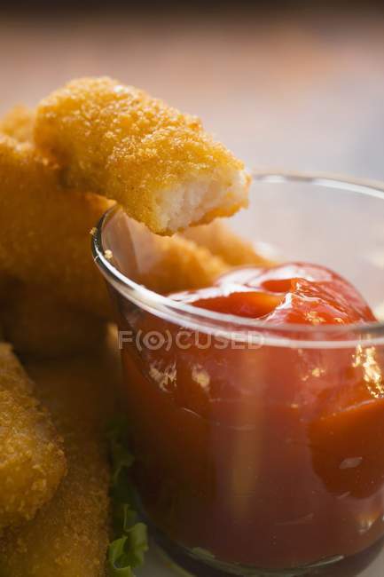 Fish finger with ketchup — Stock Photo