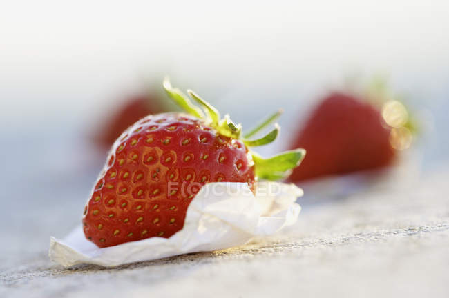 Fresh strawberry on paper — Stock Photo