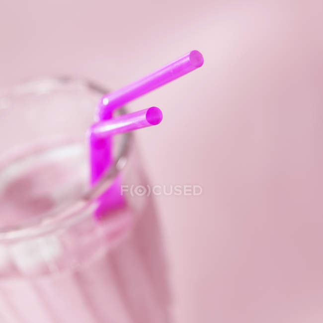 Berries in glass with straws — Stock Photo