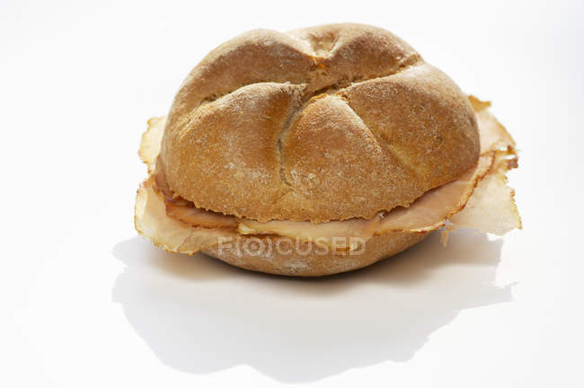 Bread roll filled with Tyrolean ham — Stock Photo