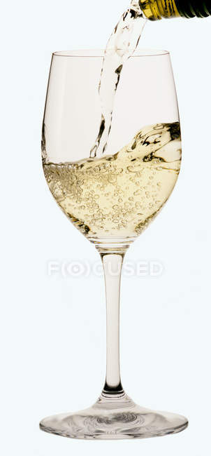 Pouring wine into glass from bottle — Stock Photo