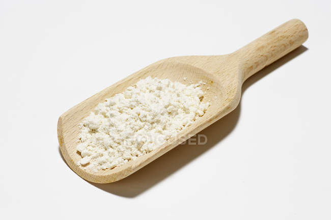 Flour on a wooden scoop — Stock Photo