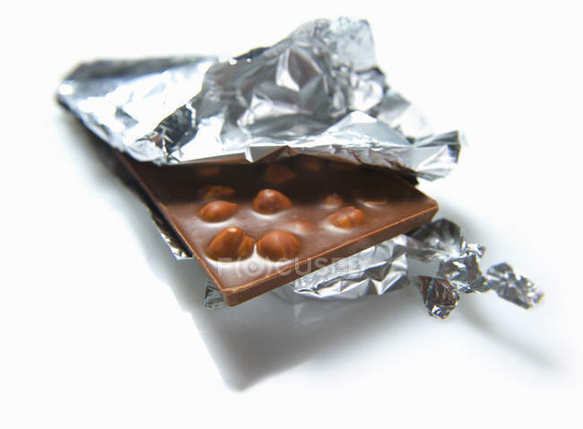 Opened bar of nut chocolate — Stock Photo