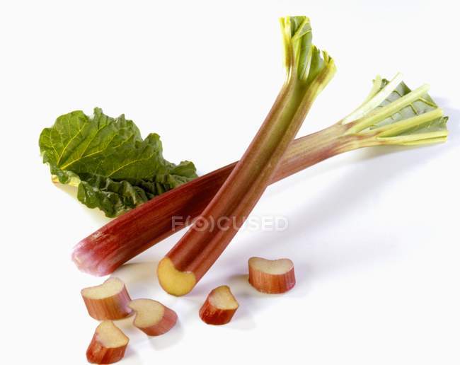 Bâtonnets de rhubarbe fraîche avec des tranches — Photo de stock