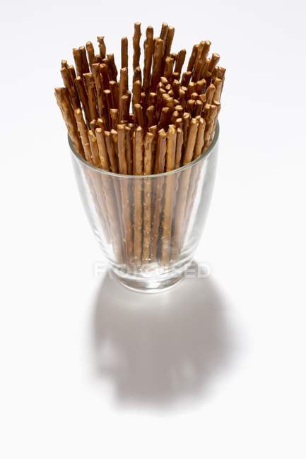 Elevated view of salted straws in a glass on white surface — Stock Photo