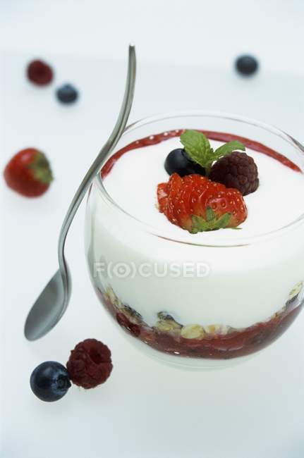 Berries in glass with spoon — Stock Photo