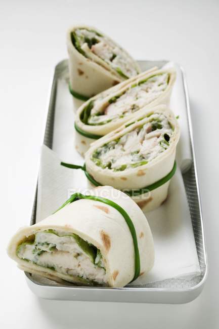 Closeup view of four wraps with fish filling — Stock Photo