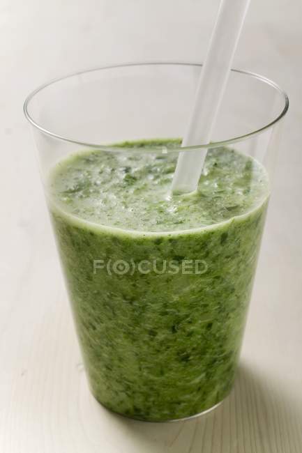 Glass of herb drink with straw — Stock Photo
