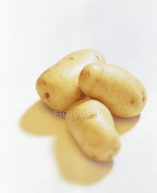 Three whole fresh potatoes — Stock Photo
