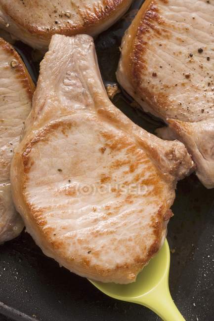 Жареная свиная отбивная на сковородке — стоковое фото