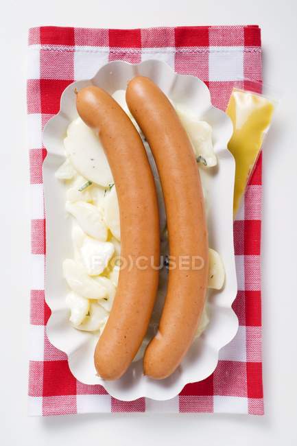 Frankfurters on potato salad — Stock Photo