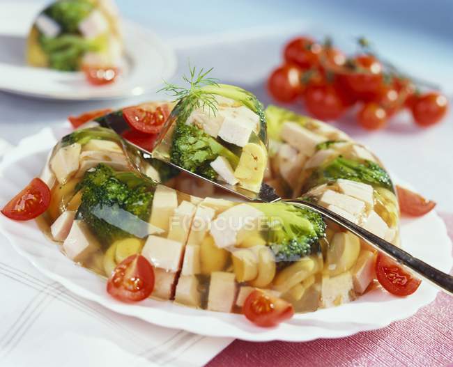 Ham and broccoli in aspic on white plate  with spoon — Stock Photo