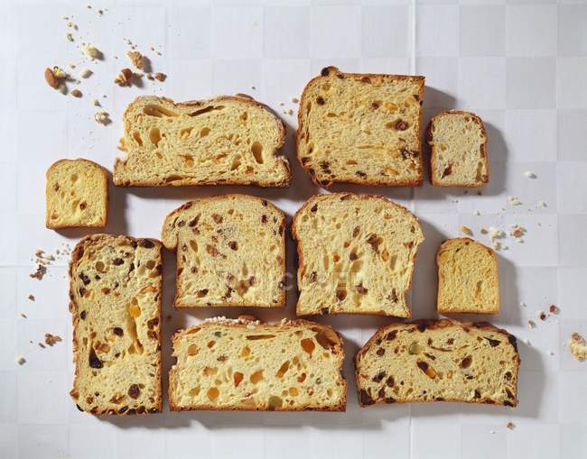 Top view of Panettone slices arranged on white surface — Stock Photo