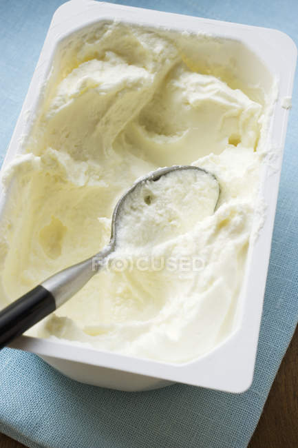 Closeup view of Quark in opened packaging with spoon — Stock Photo