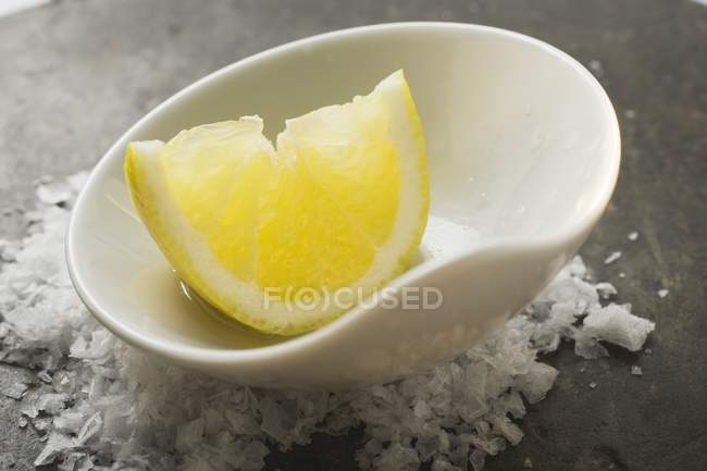 Lemon wedge with olive oil — Stock Photo