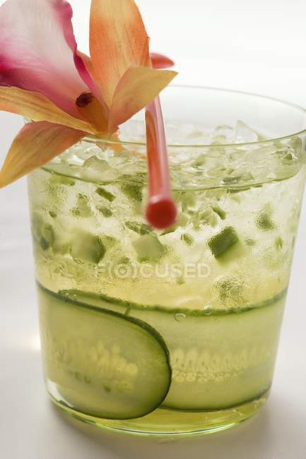 Refreshing cucumber drink with flower over white background — Stock Photo