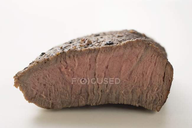 Beef steak with a piece cut off — Stock Photo