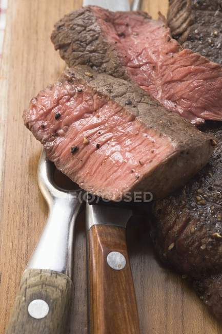 Beef steaks, partly sliced — Stock Photo
