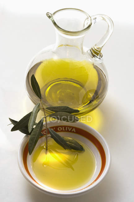 Olive oil with olive branch — Stock Photo