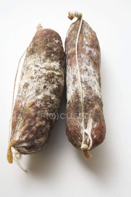 Two whole Italian cured salamis — Stock Photo