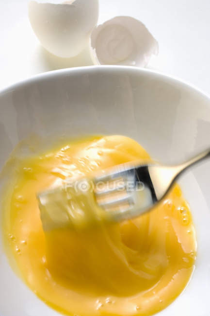 Beating egg with fork — Stock Photo