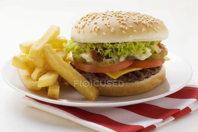 Cheeseburger with mayonnaise and chips — Stock Photo