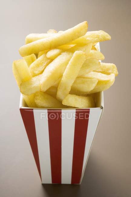 Chips in striped box — Stock Photo