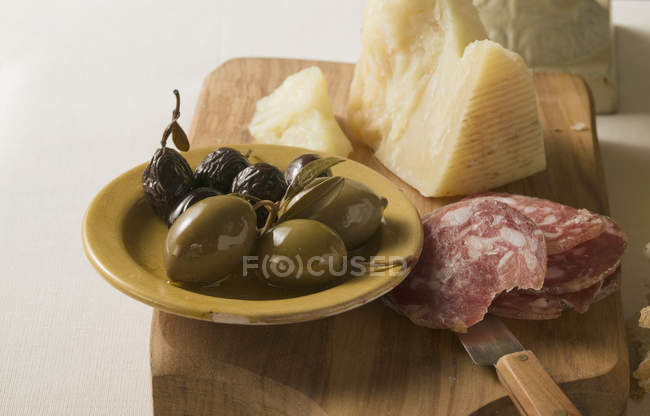Olives with sliced sausage and Parmesan — Stock Photo
