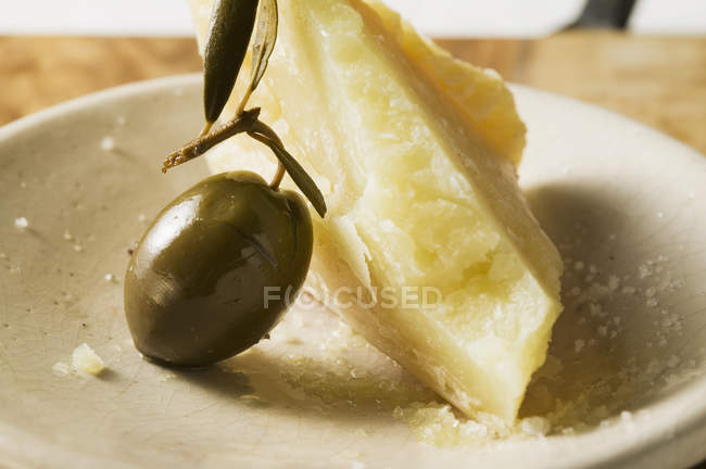 Вид крупным планом на зеленую оливку и пармезан — стоковое фото