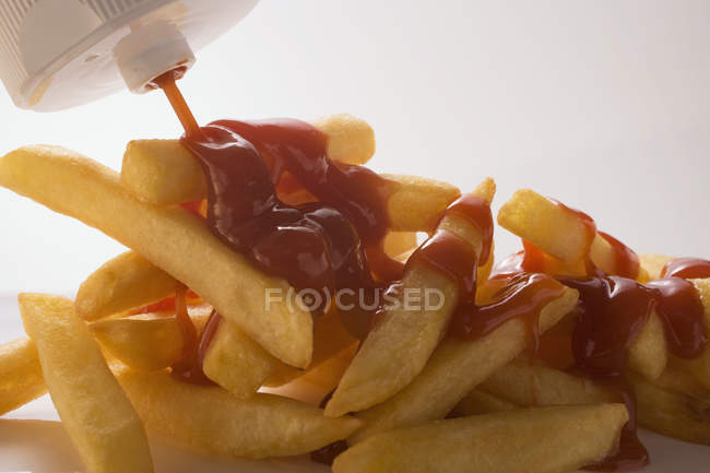 Ketchup on french potato fries — Stock Photo
