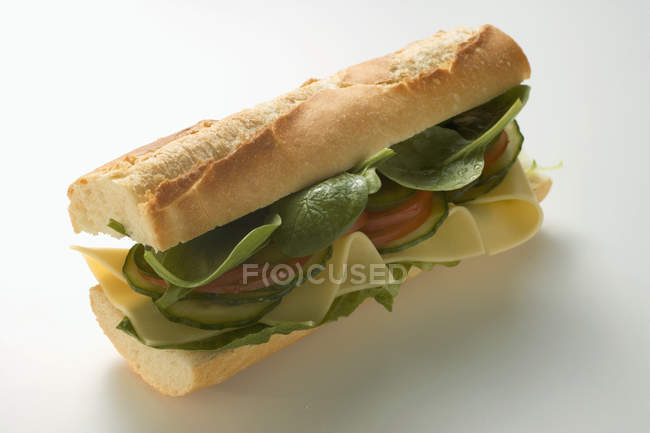 Baguette with cheese and salad — Stock Photo