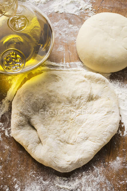 Top view of raw dough with flour and oil — Stock Photo