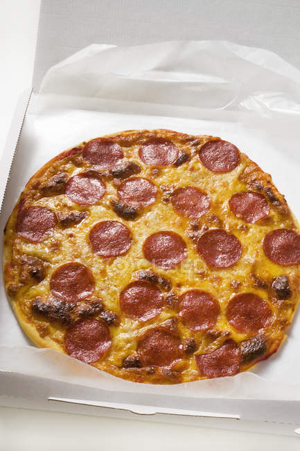 Whole salami and cheese pizza — Stock Photo