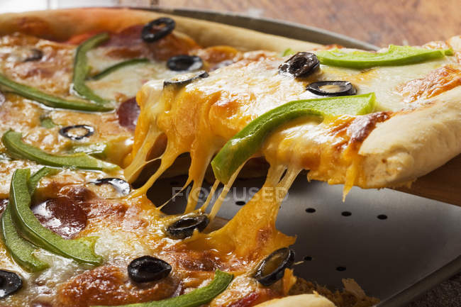 Pizza with cheese, salami and peppers — Stock Photo