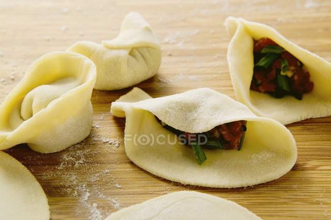 Filling pasta parcels with beef — Stock Photo