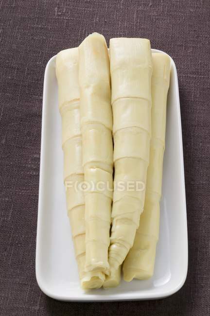 Bamboo shoots on white platter — Stock Photo