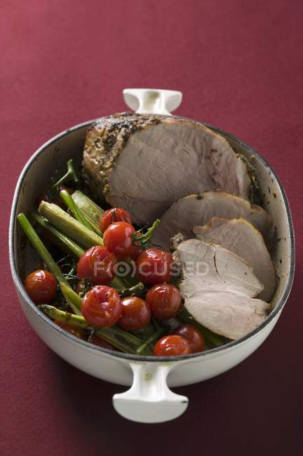 Roasted pork with cherry tomatoes — Stock Photo
