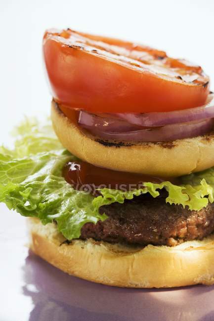 Домашний гамбургер с помидорами на гриле — стоковое фото