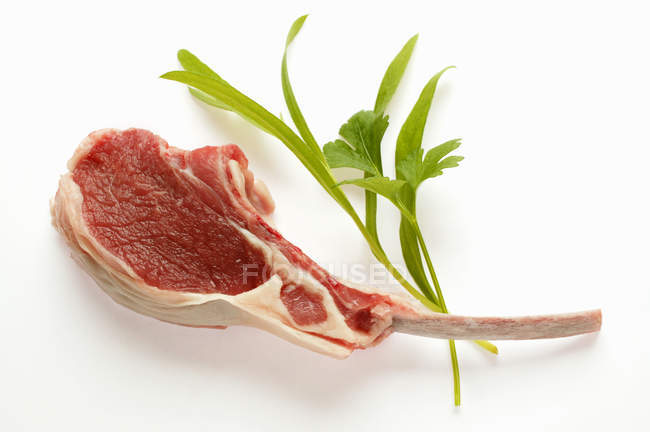 Lamb cutlet and fresh herbs — Stock Photo