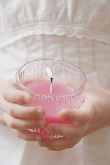 Closeup cropped view of girl holding burning scented candle — Stock Photo